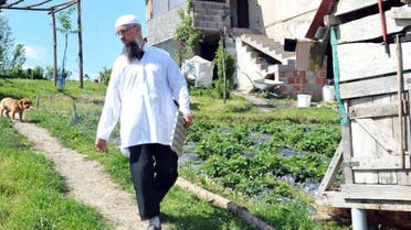 Izet Hadzic, selfproclamed imam of a rebellious Muslim congregation in a secluded village of Osve, near Central Bosnian town of Maglaj, walks in front of his house in Osve on May 18, 2016. AFP