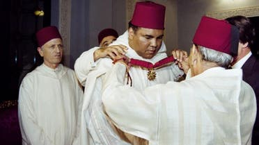 This file photo taken on January 15, 1998 shows Moroccan King Hassan II (R) decorating former World Heavyweight Champion Muhammad Ali during a ceremony in the Royal Palace in Rabat. (AFP)
