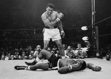 Heavyweight champion Muhammad Ali stands over fallen challenger Sonny Liston, shouting and gesturing shortly after dropping Liston with a short hard right to the jaw on May 25, 1965, in Lewiston, Maine. (AP)