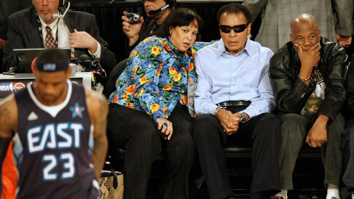 Muhammad Ali (2nd R) watches during the first quarter of the NBA All-Star basketball game in Phoenix, Arizona, February 15, 2009. REUTERS
