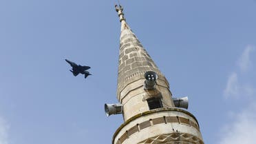 A Turkish Air Force F-4E fighter flies over a minaret after taking off from Incirlik air base in Adana, Turkey, August 12, 2015. REUTERS