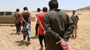 Men, who the Democratic Forces of Syria fighters claimed were ISIS fighters, walk as they are taken prisoners after SDF advanced in the southern rural area of Manbij, in Aleppo Governorate, Syria May 31, 2016 (File Photo: REUTERS)