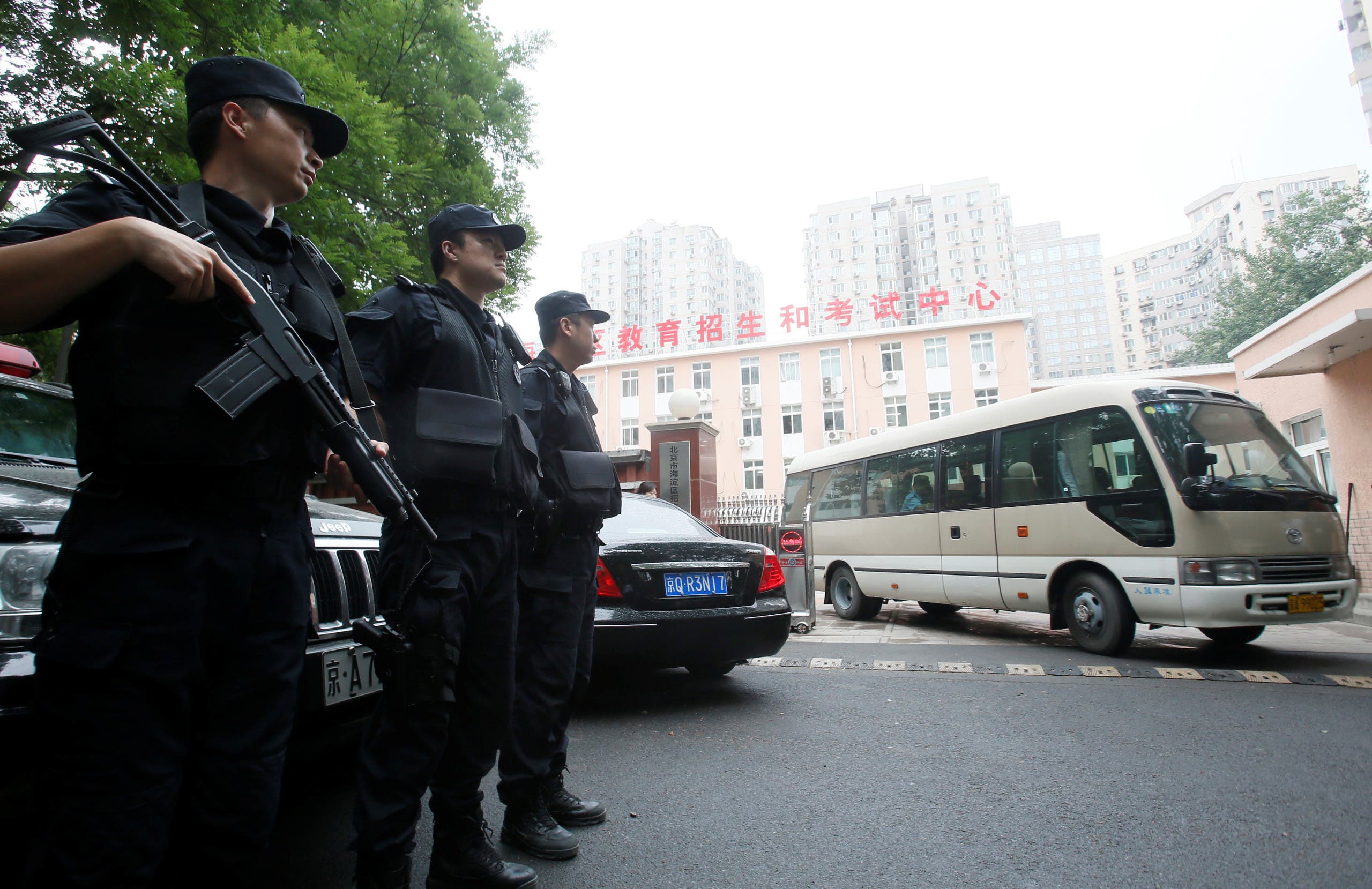 China's Special Weapons and Tactics (SWAT) team members guard for examination paper outside of an education centre during China's annual National College Entrance Exam in Beijing, China