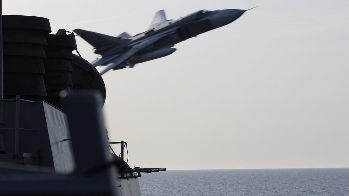 In this image released by the U.S. Navy, a Russian SU-24 jet makes a close-range and low altitude pass near the USS Donald Cook on Tuesday, April 12, 2016, in the Baltic Sea. The Russian attack planes buzzed the U.S. Navy destroyer multiple times on Monday and Tuesday, at one point coming so close, an estimated 30 feet, that they created wakes in the water around the ship, a U.S. official said Wednesday, April 13. (U.S. Navy via AP)