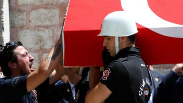 A comrade mourns as honour guards carry the coffin of police officer Karagozlu who was killed in Tuesday's car bomb attack on a police bus, during a funeral ceremony at Fatih mosque in Istanbul. (Reuters)