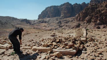 This undated handout image, provided by Dr. Christopher A. Tuttle, Executive Director of the Council of American Overseas Research Centers, shows U.S. archaeologist Christopher A. Tuttle investigating the doorsill of the small building on the platform, looking southwest in Petra, Jordan. AP