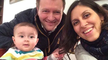 Nazanin Zaghari-Ratcliffe (R) poses for a photograph with her husband Richard and daughter Gabriella (L) (AFP)