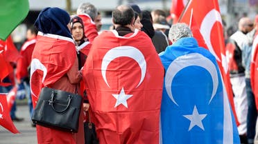 Pro-Turkish protestors wearing Turkish flags take part in a demonstration in Hamburg, April 10, 2016. A 'Peace March for Turkey and the EU', organized by "Avrupa Yeni Turkler Komitesi" (AYTK, European New Turks Committee) was held in Hamburg and other German cities on Sunday. Counter-demonstrations by Kurdish and leftist groups were simultaneously held to demonstrate against what they say are the nationalist-Islamist policies of Turkish President Tayyip Erdogan. REUTERS