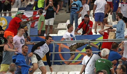 Russian supporters attack England fans at the end of the Euro 2016 Group B soccer match between England and Russia, at the Velodrome stadium in Marseille, France, Saturday, June 11, 2016. (AP