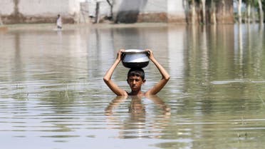 A boy carries a pot on his head as he moves through floodwaters at Camp Koruna Akbar in the Pura area of Nowshera District, northwestern Pakistan, August 4, 2015. Flash flooding caused by torrential monsoon rains affected hundreds of thousands of people, according to aid agencies, with further monsoon downpours expected in the coming days. REUTERS/Fayaz Aziz
