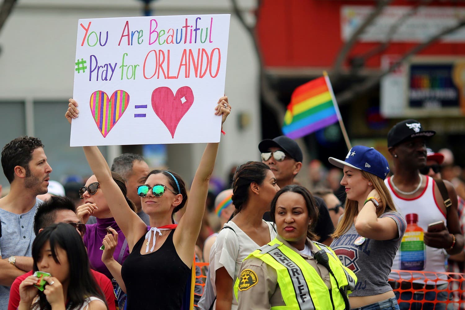 Kristen Jaeger holds a sign of remembrance for mass shooting victims in Orlando, at the 46th annual Los Angeles Gay Pride Parade in West Hollywood, California, U.S. June 12, 2016. REUTERS