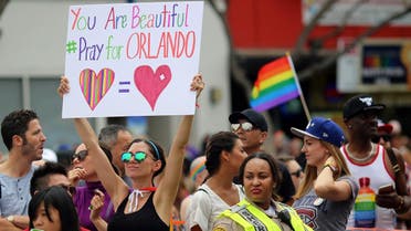 Kristen Jaeger holds a sign of remembrance for mass shooting victims in Orlando, at the 46th annual Los Angeles Gay Pride Parade in West Hollywood, California, U.S. June 12, 2016. REUTERS