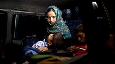  An Iraqi boy sleeps in his mother's arms in a minibus after fleeing Fallujah, during a military operation to retake the city from Islamic State militants, outside Camp Tariq, on the outskirts of Fallujah, Iraq, Monday, June 6, 2016. (AP Photo/Maya Alleruzzo)