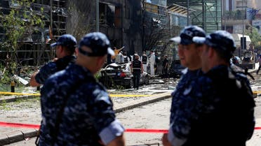 Policemen secure the area as forensic inspectors examine the site of an explosion outside the headquarters of the Lebanese Blom Bank in Beirut, Lebanon June 13, 2016. reuters