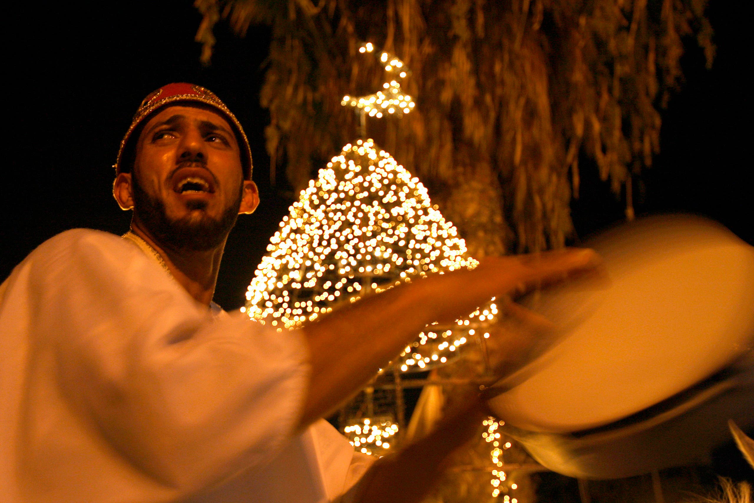 A Mesaharaty, or dawn awakener, strikes his drum to wake observant Muslims for their overnight 'sahur', or last meal, before the day's fast in Sidon's Old City in southern Lebanon just before dawn August 27, 2010.