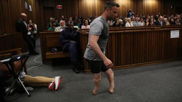 Oscar Pistorius' prosthetics lay on the floor as he walks on his stumps during argument in mitigation of sentence by his defense attorney Barry Roux in the High Court in Pretoria, South Africa, Wednesday, June 15, 2016. (AP)