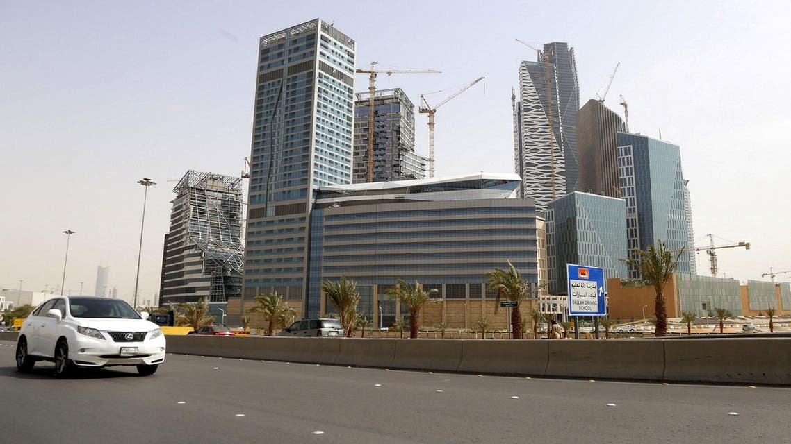 A car drives past the construction site of King Abdullah Financial District, in Riyadh, Saudi Arabia. (Reuters)