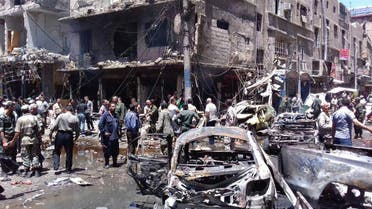 In this photo released by the Syrian official news agency SANA, Syrians gather around damaged buildings after a bombing attack at the Sayyida Zeinab suburb, Damascus, Syria, Saturday, June 11, 2016. (AP)