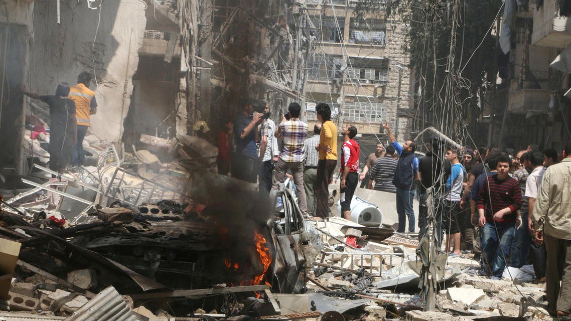 People inspect the damage at a site hit by airstrikes, in the rebel-held area of Aleppo's Bustan al-Qasr, Syria April 28, 2016. REUTERS