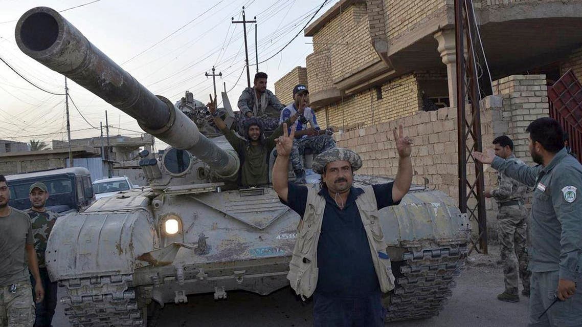 Iraqi security forces pose for a photo as they celebrate in central Fallujah, Iraq, after fighting against the Islamic State militants Friday, June 17, 2016. Iraqi special forces entered the center of Fallujah city early Friday, taking over a government complex and a neighborhood that served as a base for the Islamic State group militants after intense fighting. (AP Photo)