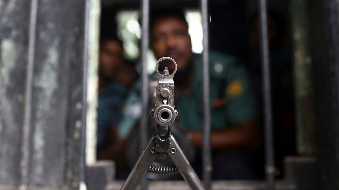 A Bangladeshi policeman mans a post outside a special war crimes tribunal ahead of a verdict for Jamaat-e-Islami chief Motiur Rahman Nizami, in Dhaka, Bangladesh, Tuesday, June 24, 2014. A Bangladesh court Tuesday delayed a verdict against Nizami charged with war crimes after the defendant became ill. (AP Photo/A.M. Ahad)