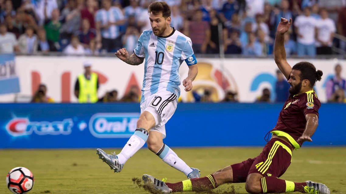 Lionel Messi scores a goal past Venezuela defender Oswaldo Vizcarrondo during the Copa America quarter-final play. (Reuters)