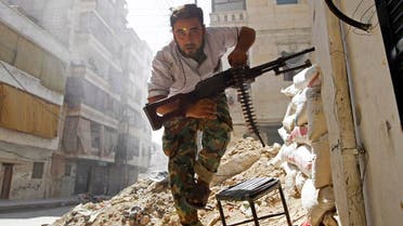 A Free Syrian Army fighter takes cover during clashes with Syrian Army in the Salaheddine neighbourhood of central Aleppo August 7, 2012. REUTERS