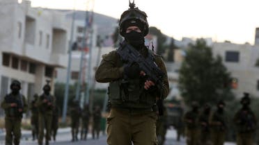 Israeli soldiers patrol a street in the northern West Bank village of Salem, east of Nablus, during an operation to arrest wanted Palestinians early on May 30, 2016. afp