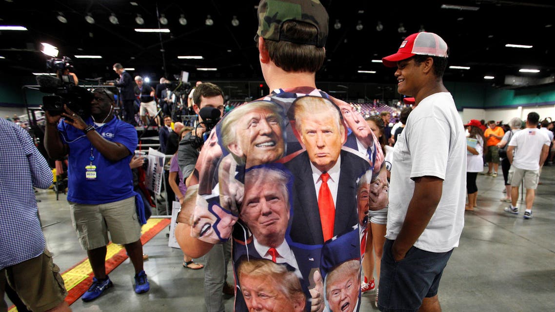 A supporter of Republican presidential candidate Donald Trump wears a shirt emblazoned with images of the politician as he is interviewed at a campaign rally in Greensboro, North Carolina on June 14, 2016. (Reuters)