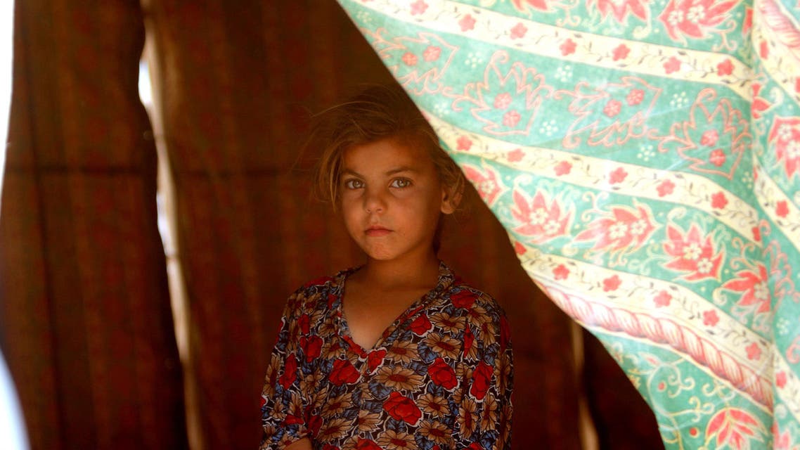 An Iraqi girl, who fled from Falluja because of Islamic State violence, poses for a photographer at a refugee camp in Ameriyat Fallujah, south of Fallujah, Iraq, June 16, 2016. (Reuters)