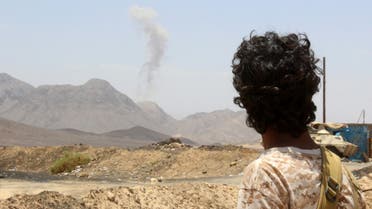 A Yemeni fighter loyal to exiled President Abedrabbo Mansour Hadi looks at smoke rising in the distance in the Sirwah area, in Marib province, on April 10, 2016, during clashes with Shiite Huthi rebels. AFP
