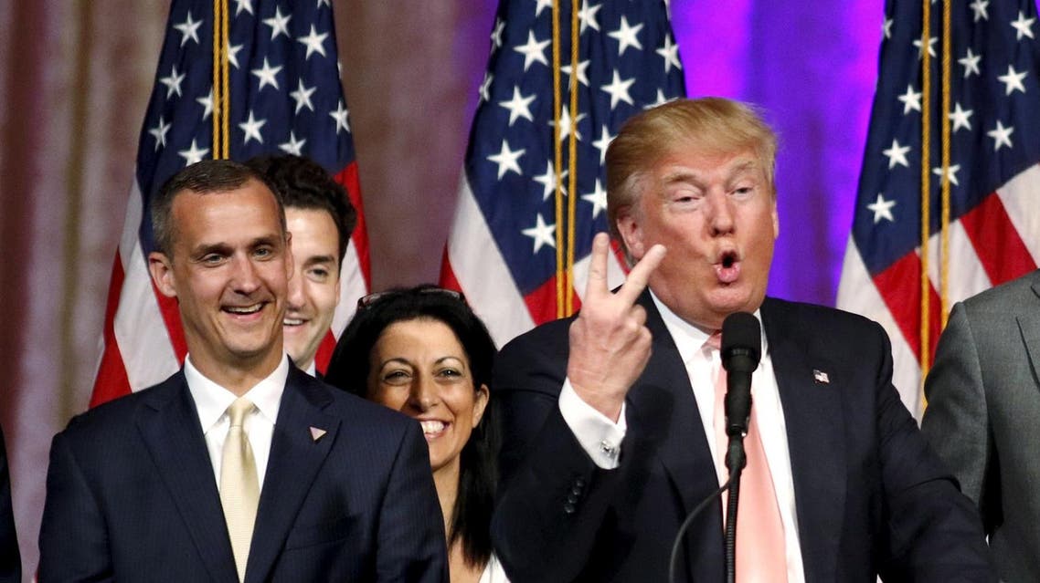 Republican U.S. presidential candidate Donald Trump's campaign manager Corey Lewandowski (L) looks on as Trump speaks about the results of the Florida, Ohio, North Carolina, Illinois and Missouri primary elections during a news conference held at his Mar-A-Lago Club in Palm Beach, Florida, U.S. on March 15, 2016. REUTERS
