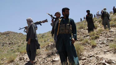 In this Friday, May 27, 2016 photo, Taliban fighters stand guard as senior leader of a breakaway faction of the Taliban Mullah Abdul Manan Niazi, not pictured, delivers a speech to his fighters, in Shindand district of Herat province, Afghanistan. In the rugged terrain of the Taliban heartland in southern Afghanistan, the fight against Kabul has become a war for control of key stretches of main roads and highways as the insurgents use a new tactic to gain ground. (AP Photos/Allauddin Khan)