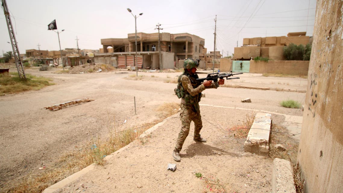 A member of the Iraqi pro-government forces patrols the al-Dhubat II (Officers) neighbourhood of Fallujah as they try to clear the city of Islamic State (IS) group fighters still holed up in the former jihadi bastion on June 19, 2016. AFP