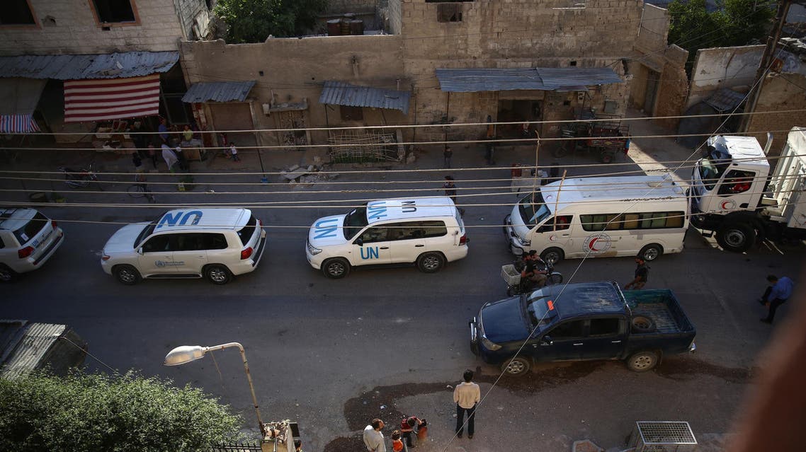 Vehicles of a UN and SARC aid convoy, with food, nutrition, health and other emergency items, enter the rebel-held town of Douma, east of the Syrian capital Damascus, on June 10, 2016.