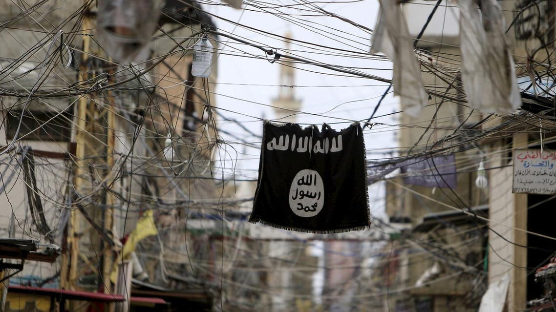 An Islamic State flag hangs amid electric wires over a street in Ain al-Hilweh Palestinian refugee camp, near the port-city of Sidon, southern Lebanon January 19, 2016. REUTERS