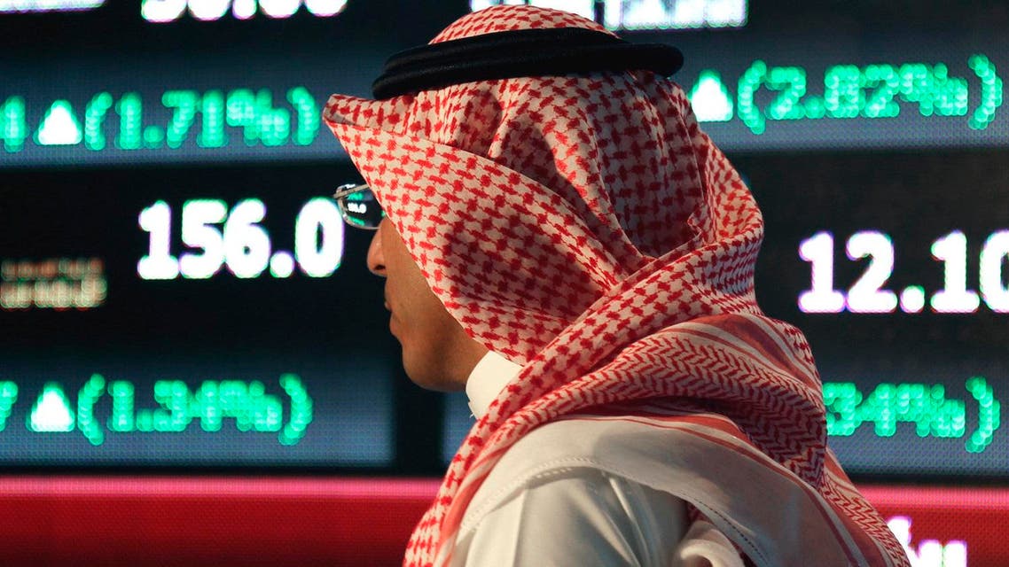 A Saudi man walks at the Tadawul Saudi Stock Exchange, in Riyadh, Saudi Arabia, Monday, June 15, 2015. Saudi Arabia's stock market, valued at $585 billion, opened up to direct foreign investment for the first time Monday, as the kingdom seeks an economic boost amid low global oil prices. (AP Photo/Hasan Jamali)
