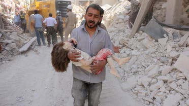 A Syrian man carries the body of a child following a reported Syrian government forces bombing at the Tariq al-Bab neighbourhood in the rebel-held area of the northern city of Aleppo on June 20, 2016. 