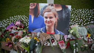 An image and floral tributes for Jo Cox, lay on Parliament Square, outside the House of Parliament in London, Friday, June 17, 2016, after the 41-year-old British Member of Parliament was fatally injured Thursday in northern England. 