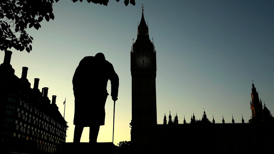 A statue of Winston Churchill is silhouetted against the Houses of Parliament and the early morning sky in London, Friday, June 24, 2016. (AP)