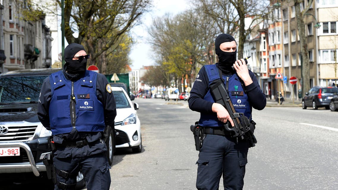 Belgian police officers stand guard in a street in Etterbeek while their colleagues search a warehouse in relation with terrorists arrests in Belgium, on April 09, 2016. A sixth person was arrested during raids on April 8, 2016 over the Brussels airport and metro bombings which netted top Paris attacks suspect Mohamed Abrini, the Belgian prosecutor's office said. THIERRY CHARLIER / AFP