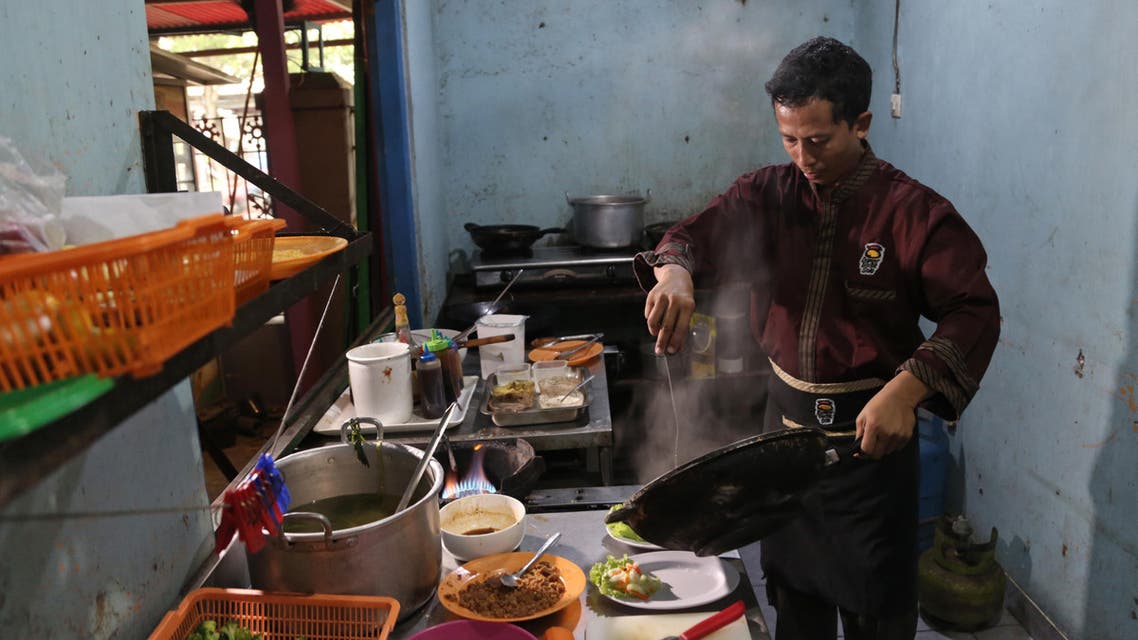 In this Monday, May 16, 2016 photo, Mahmudi Haryono, 40, who is also known by his militant alias "Yusuf Adirama" cooks in the kitchen of his restaurant in Solo, Central Java, Indonesia. (ap)