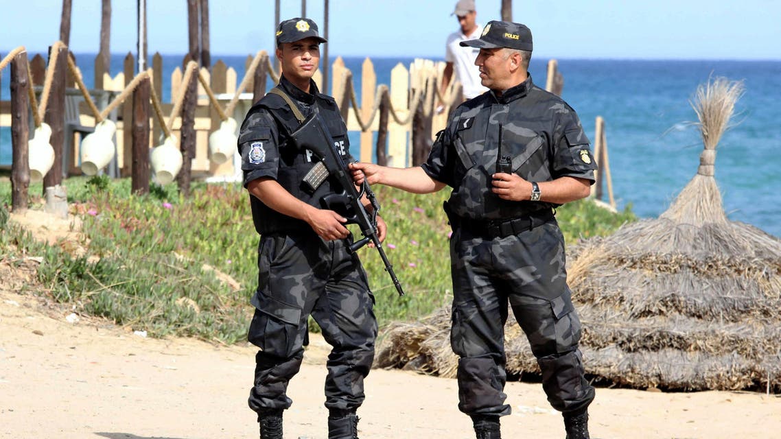 Tunisian policemen stand guard at a beach in the coastal resort of Hammamet, some 60 kms south-east of Tunis, on June 18, 2016.