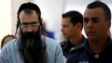 Yishai Schlissel (C), convicted of killing a woman during the 2015 Jerusalem Gay Pride Parade, is escorted by security personnel before he is sentenced at the Jerusalem District Court June 26, 2016. (Reuters)