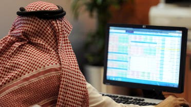 A Saudi investor monitors the stock exchange at the Al-Bilad Saudi Bank on June 15, 2015 in the capital Riyadh. Saudi Arabia's stock exchange allowed foreign investors to trade shares for the first time, boosting efforts by the world's top oil exporter to become a major global capital market. AFP PHOTO / FAYEZ NURELDINE 