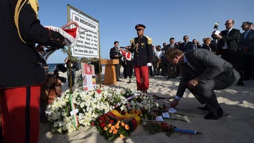 Britain's Foreign Office junior minister, Tobias Ellwood, lays a flower on the beach on June 26, 2016, during a ceremony in memory of those killed a year ago by a jihadist gunman in front of the Riu Imperial Marhaba Hotel in Port el Kantaoui, on the outskirts of Sousse south of the capital Tunis. Tourists fled in horror on June 26, 2015 as a Tunisian gunman pulled a Kalashnikov rifle from inside a furled beach umbrella and went on a shooting spree outside the five-star hotel. 30 Britons were among 38 foreign holidaymakers killed in the attack. FETHI BELAID / AFP