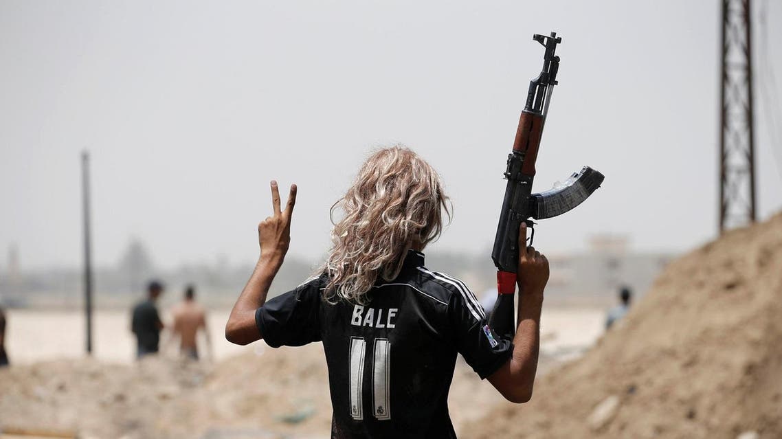 A member of Iraqi government forces celebrate along a street in Falluja after government forces recaptured the city from Islamic State militants, Iraq, June 27, 2016. REUTERS