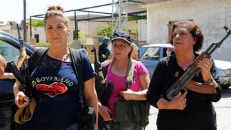 Lebanese women in Christian village carry guns after suicide blasts