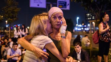 Passengers embrace outside Ataturk airport`s main enterance in Istanbul, on June 28, 2016, after two explosions followed by gunfire hit Turkey's largest airport. (AFP)