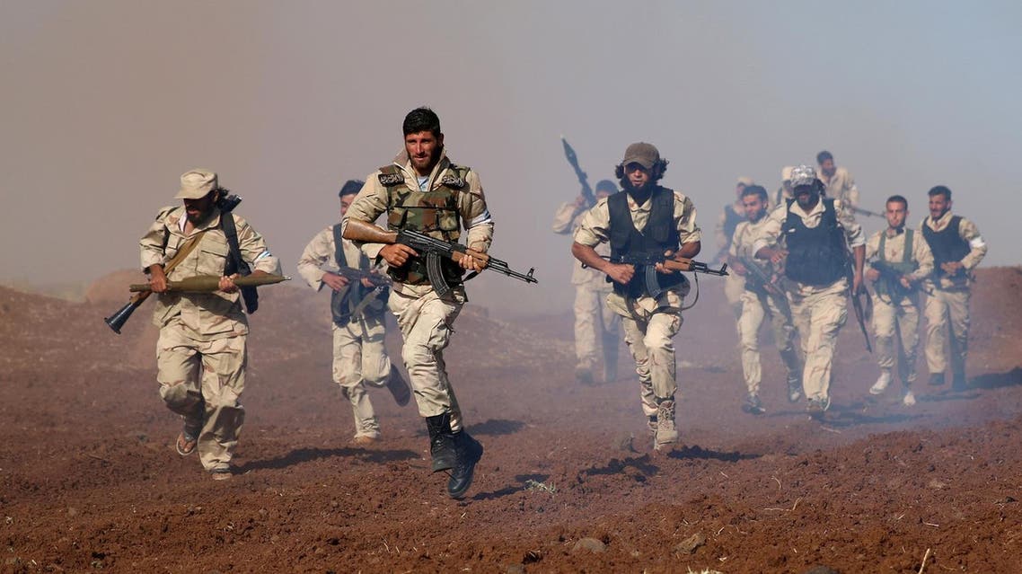 Rebel fighters from 'Mujahideen Horan brigade' carry their weapons as they take part in military training in the western rural area of Deraa Governorate, Syria June 19, 2016. REUTERS